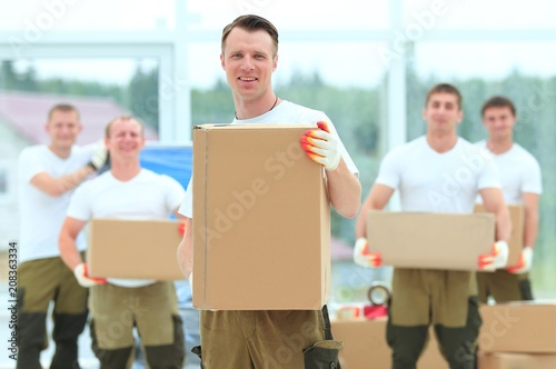 foreman and workers with boxes of building materials