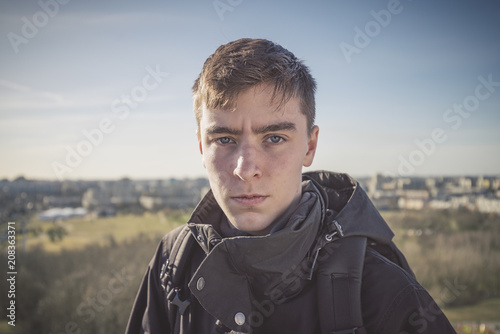 Photography portrait of a young man with a panorama of houses in background