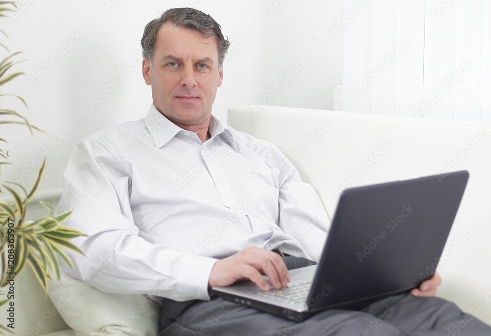 businessman with laptop works in the room businessman with laptop works in the room