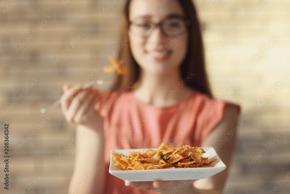 Young woman eating delicious pasta indoors, closeup Young woman eating delicious pasta indoors, closeup