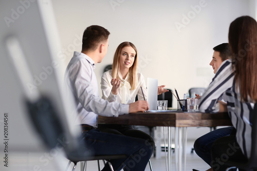 Young people having business meeting in office