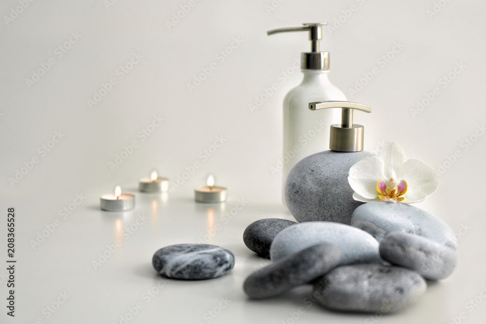 Spa composition with stones and cosmetics on light background Spa composition with stones and cosmetics on light background