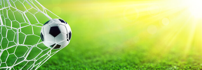 Soccer Ball In Goal With Sunlight
