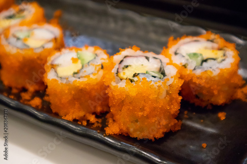 California maki sushi roll on black plate, japanese food