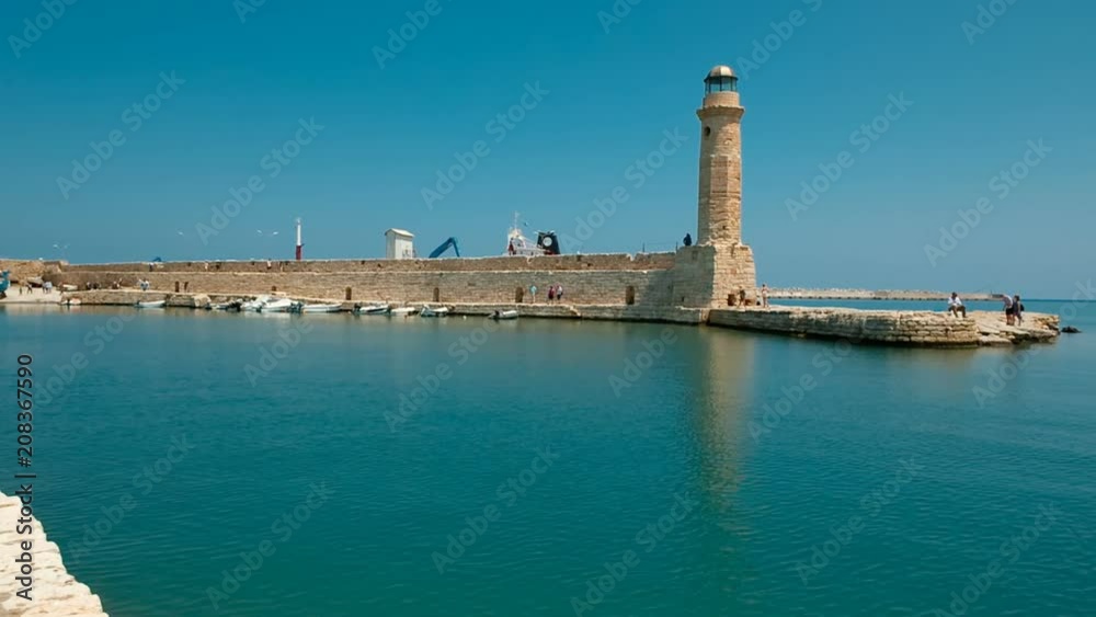 Establishing shot of the sea port and Venetian lighthouse in the coastal town of Rethymno, Crete, Greece Establishing shot of the sea port and Venetian lighthouse in the coastal town of Rethymno, Crete, Greece