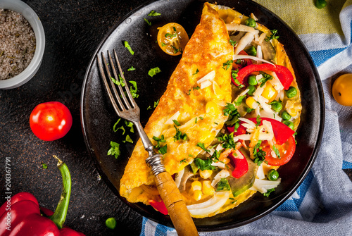 Healthy breakfast food, Stuffed egg omelette with vegetable, dark concrete background copy space top view photo