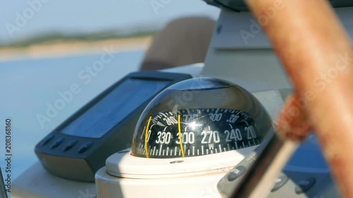 Closeup on navigating instruments behind steering wheel of sailing boat. Filmed on sailing trip in Croatia in slow motion hd.