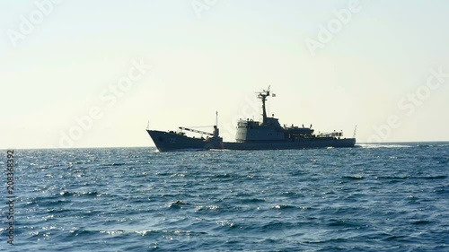 Military ship in Adriatic sea at evening shot from sailing boat. Filmed from moving sailing boat while sailing in Croatia.