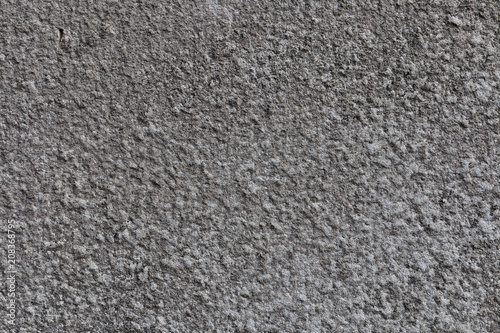 Gray background of concrete with pits and indentations.