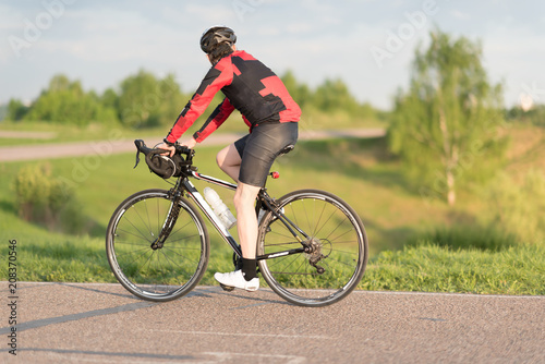 A cyclist in helmet riding a bike on a special asphalt velo road