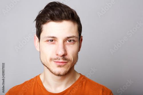 Close up handsome young man against gray background