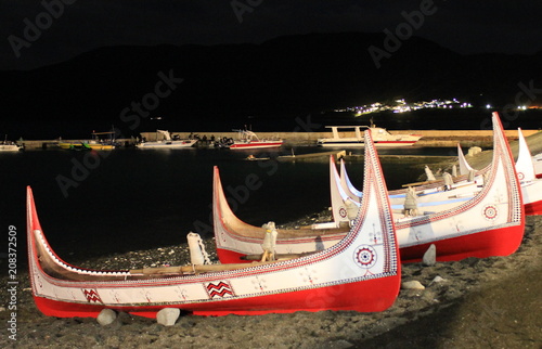 Aboriginal Canoe with Beautiful Feather Decoration on the Beach of Lanyu During Flying Fish Festival at Taitung, Taiwan photo