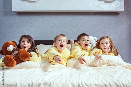 The group of friends taking goog time on bed