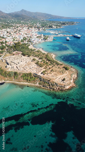 Aerial drone bird's eye view of iconic temple of Apollo on top of Kolona hill with only one pillar left standing, Aigina island, Saronic gulf, Greece © aerial-drone
