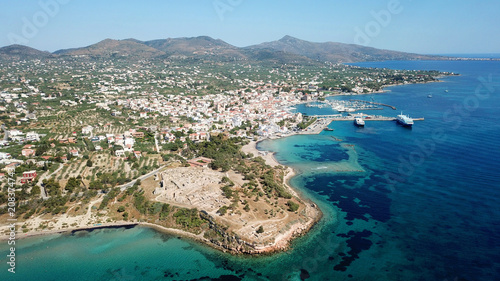 Aerial drone bird's eye view of iconic temple of Apollo on top of Kolona hill with only one pillar left standing, Aigina island, Saronic gulf, Greece © aerial-drone