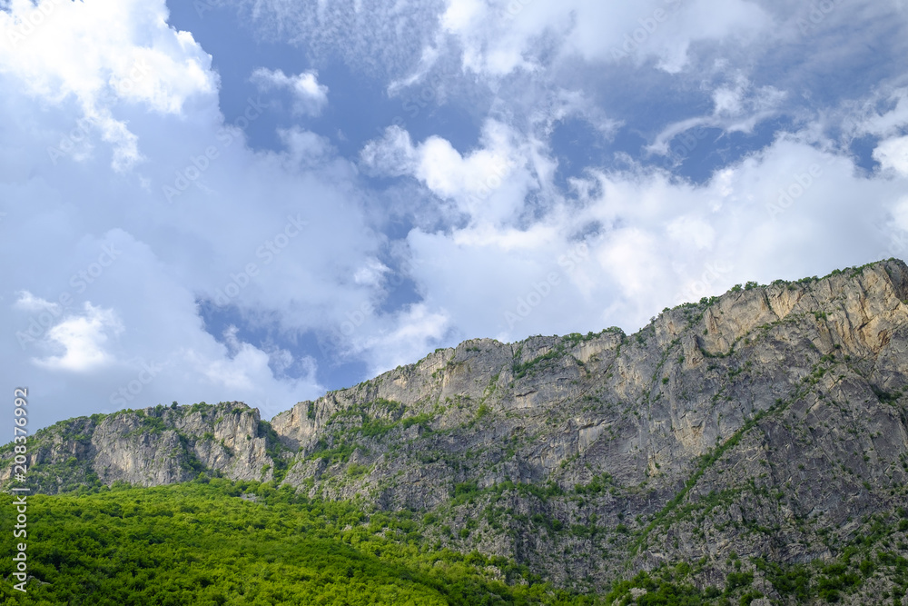 Mountain ridge surrounded by green on a cloudy sky 1 Mountain ridge surrounded by green on a cloudy sky 1