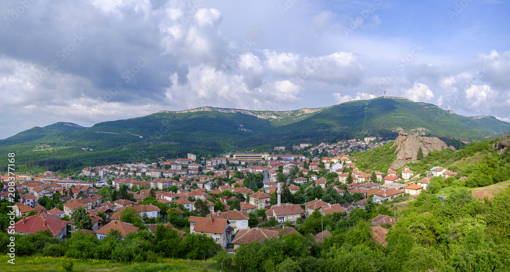 Panorama of a city in the mountains on a background of a cloudy sky 1