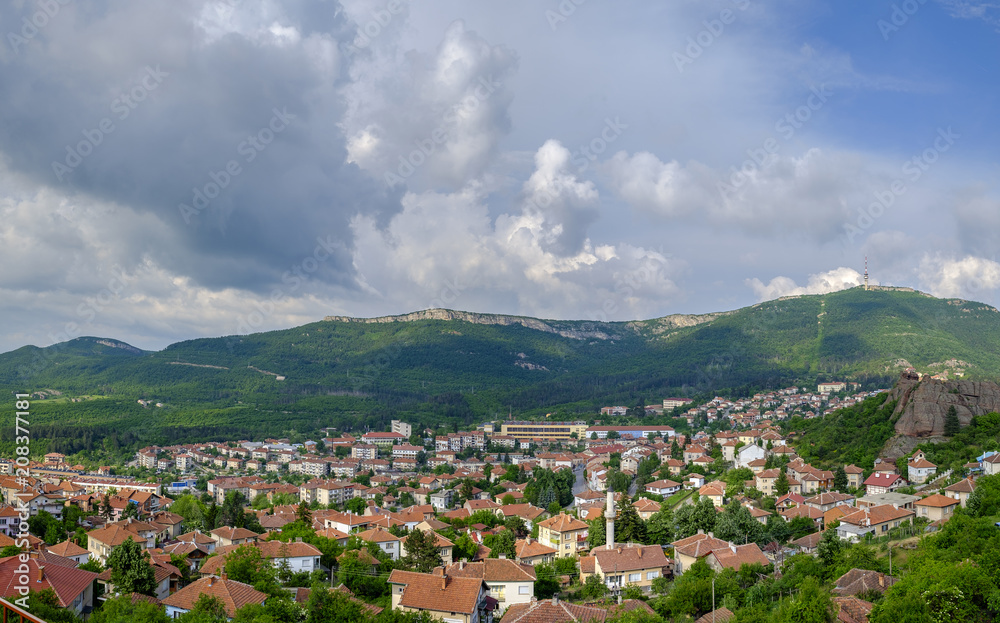 Panorama of a city in the mountains on a background of a cloudy sky 2