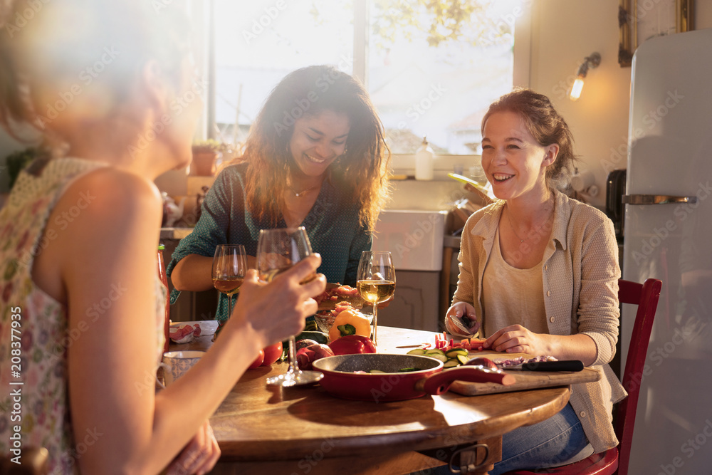 Multi-ethnic group of friends having fun while preparing lunch Multi-ethnic group of friends having fun while preparing lunch