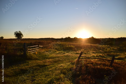 Sunrise Over a Field With Gate