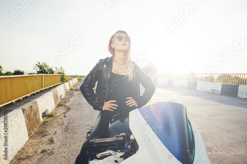 Biker woman looking interested to the sky 