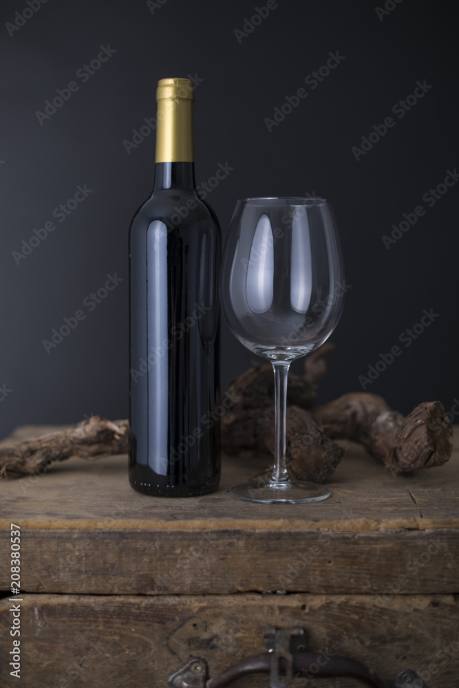 Wine bottle on a Old wood case on a black Background