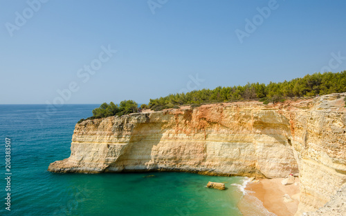 View of the golden limestone cliffs and Atlantic ocean near Benagil village. Algarve, District Faro, Southern Portugal.