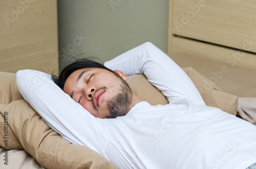 Man deep sleeping, Handsome man in white sleepwear take a nap in bedroom.