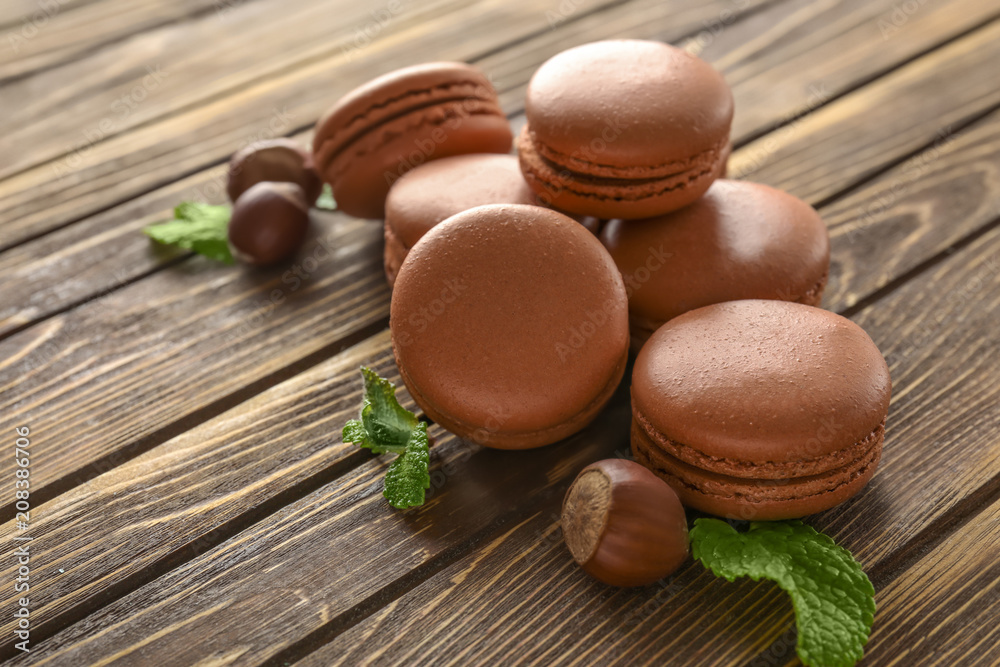 Tasty chocolate macarons on wooden background Tasty chocolate macarons on wooden background