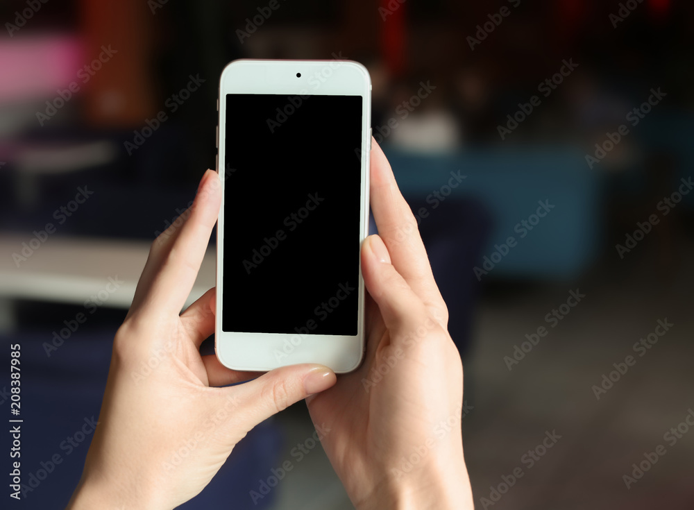 Woman using mobile phone on blurred background Woman using mobile phone on blurred background