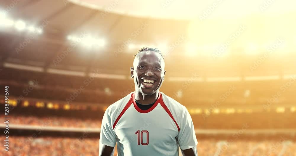 Happy soccer player on a football stadium Happy soccer player on a football stadium
