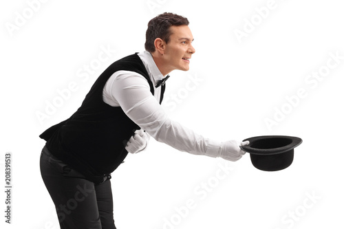 Waiter bowing down and taking his hat off photo