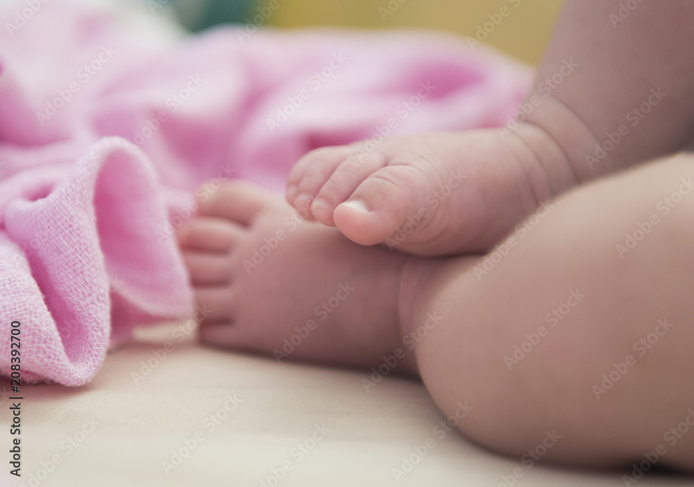 Small foots of newborn baby on pink blanket Small foots of newborn baby on pink blanket
