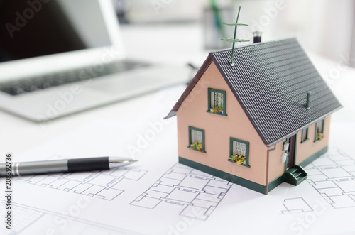 House model on desk, mortgage or house building concept
