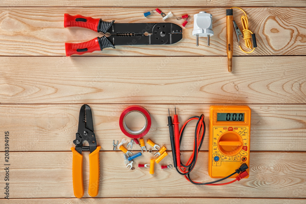 Flat lay composition with electrical tools on wooden background Flat lay composition with electrical tools on wooden background
