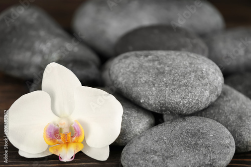 Spa stones with beautiful orchid flower  closeup
