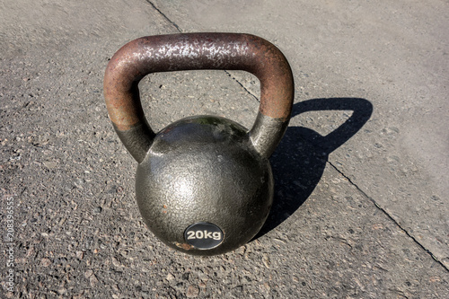 Fototapeta Naklejka Na Ścianę i Meble -  Rusty old dumbbell for weightlifting weighing 20 kg