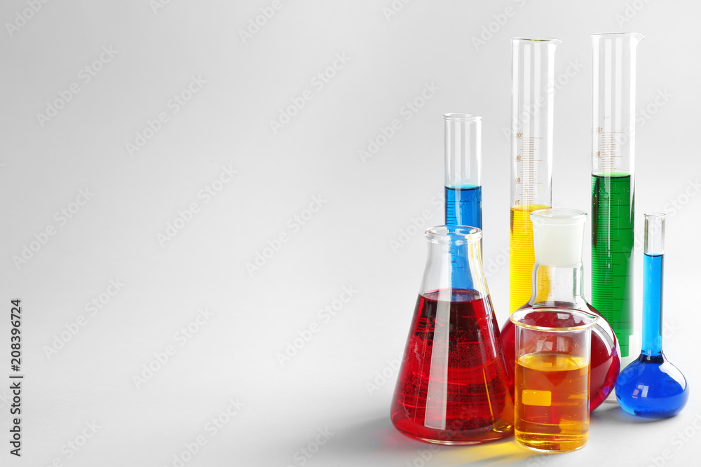 Chemical glassware with colorful liquids on light background Chemical glassware with colorful liquids on light background