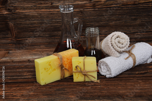 sea buckthorn oil, two home-made glycerin soaps with pieces of orange peel and lemon peeling, two towels with free space for text