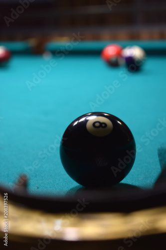colored balls of the American pool and cue on the billiard table