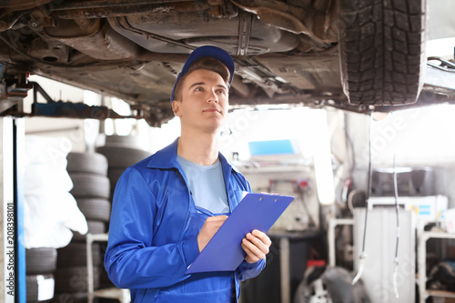 Male mechanic with clipboar...