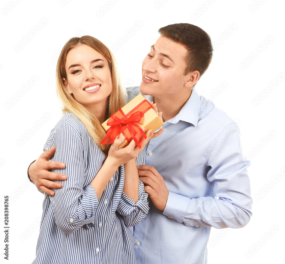 Happy young couple with gift box on white background Happy young couple with gift box on white background