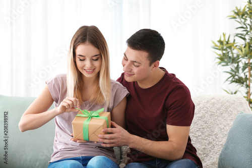 Young woman with gift from ...