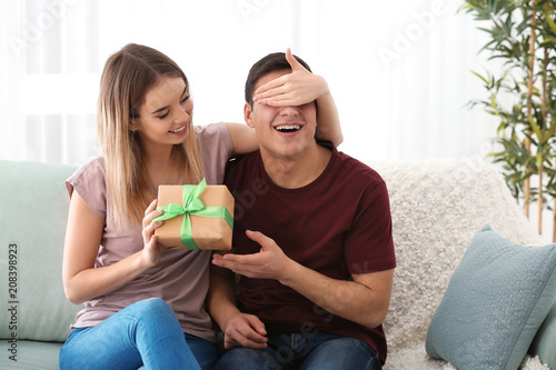 Young woman giving present ...