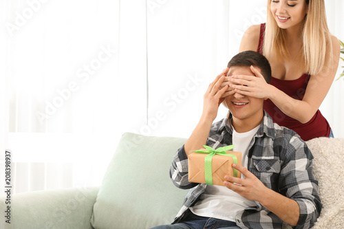 Young woman giving present ...