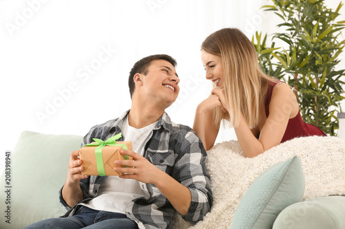 Young woman giving present ...