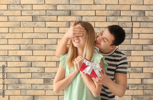 Young man giving present to...