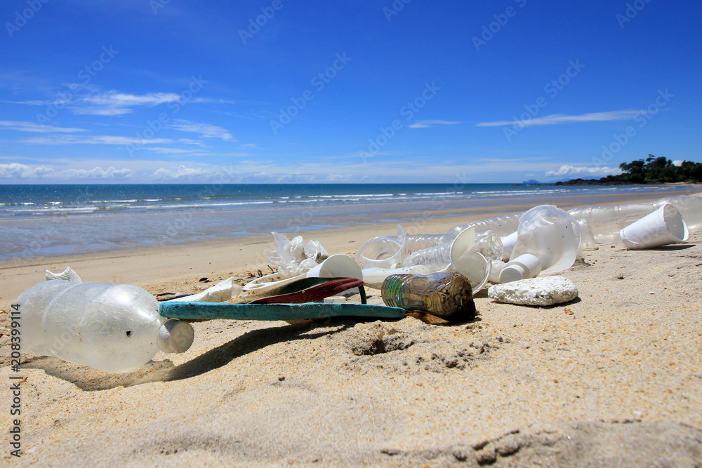 Plastic pollution on beach. Plastic bottles, bags and other garbage washes up in beach Plastic pollution on beach. Plastic bottles, bags and other garbage washes up in beach