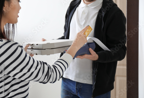 Customer paying for pizza d...