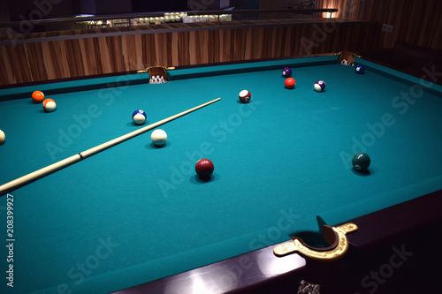 colored balls of the American pool and cue on the billiard table
